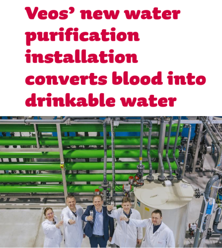 Screenshot of article headline and cover picture that reads: Veos' new water purification installation converts blood into drinkable water. In the accompanying cover picture four people in white scientist coats and one in a suit can be seen smiling, holding glasses with what appears to be water.