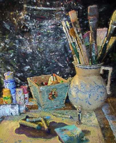 A mixed media artwork made with photography and acrylic paint of paint brushes in a blue and white jug, pastels lying on paper, and tubes of paint.