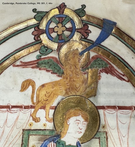 Detail of a leaf in a medieval manuscript: folio 44 verso in Cambridge, Pembroke College manuscript 301. The gold-haloed head of an evangelist peeks up from the lower edge of the image. Above this curve 2 concentric arches linked together by a decorative rosette, all rendered in shiny gold leaf with burgundy, pine, and cobalt paints. In front of the arches, springing across the page, stretches a yellow lion sporting green and red wings and a glittering halo of burnished gold. Rearing up on hind legs, the beast grasps a golden book in its front paws, and throws back its head to sound the long blue trumpet extending from its mouth.