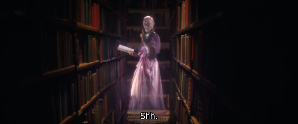 a screenshot of a Ghostbuster movie with a ghost in a library with a book in the hand looking at the camera and making a "shht" gesture